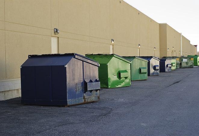 a row of heavy-duty dumpsters ready for use at a construction project in Azusa